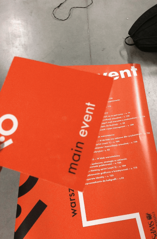 Close-up of orange Main Event printed materials